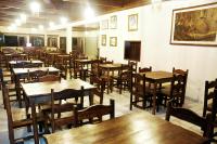 a dining room with wooden tables and chairs at Hotel Marina Clube de Pesca in Cananéia