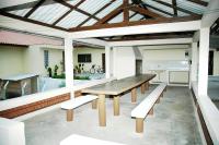 a wooden table and benches on a patio at Hotel Marina Clube de Pesca in Cananéia