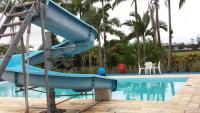 a blue slide next to a swimming pool at Hotel Marina Clube de Pesca in Cananéia