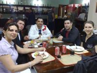 a group of people sitting at a table eating food at Hotel Marina Clube de Pesca in Cananéia