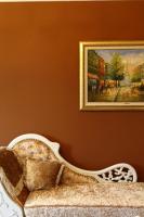 a painting on a wall next to a couch with a picture at Haut Rhin Villa in Zhuangwei