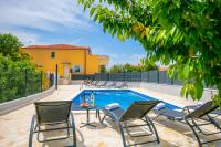 a patio with chairs and a swimming pool at Villa &quot;Mile&quot; in Katuni