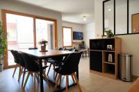 a dining room with a table and chairs at Le Cosy green - Appart 3ch + balcon - neuf in Saint Etienne