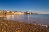 a large body of water with buildings in the background at Hostellerie De La Mer in Crozon