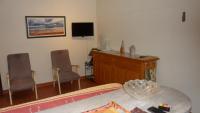 a bedroom with a desk and two chairs and a television at valras appartement T2 proche mer et port in Valras-Plage