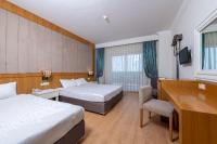 a hotel room with two beds and a desk at Lake River Side Hotel Spa in Side