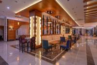 a lobby of a hotel with tables and chairs at Lake River Side Hotel Spa in Side