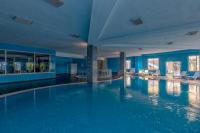 a swimming pool in a hotel with blue walls at Lake River Side Hotel Spa in Side