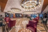 a lobby with red chairs and a chandelier at Lake River Side Hotel Spa in Side