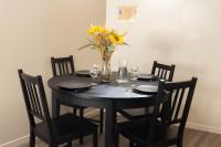 a black table with chairs and a vase of flowers at Le Petit Mondi in Mareuil-sur-Cher