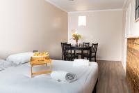 a room with two beds and a dining room with a table at Le Petit Mondi in Mareuil-sur-Cher