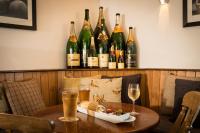 a table with a plate of food and glasses of wine at The Lordleaze Hotel And Restaurant in Chard