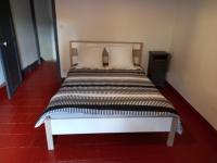 a bed with black and white sheets and pillows at Le Midi 2 in Trèbes