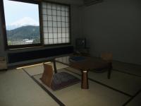 a room with a table and a view of a mountain at Guesthouse Sakuya in Fujikawaguchiko
