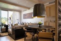 a living room with a table and a couch at Jumeirah Muscat Bay Oman in Muscat