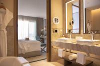 a bathroom with two sinks and a mirror at Jumeirah Muscat Bay Oman in Muscat