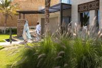 two men walking in front of a building at Jumeirah Muscat Bay Oman in Muscat