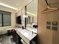 a bathroom with a sink and a counter with a mirror at Hotel Midtown Richardson in Taipei