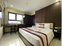 a bedroom with a bed with two swans on it at New Tourane Hotel in Danang