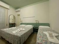 Posteľ alebo postele v izbe v ubytovaní Hotel Nanni Garnì