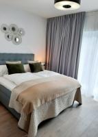 Postel nebo postele na pokoji v ubytování Apartamenty na Spokojnej