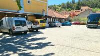 a group of vehicles parked on a city street at Restaurant &amp; rooms Visovac - best value in Skradin