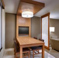 a dining room with a table and a television at Hyatt Place Boise/Downtown in Boise