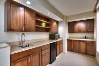 a kitchen with wooden cabinets and a sink at Hyatt Place Boise/Downtown in Boise