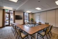 a conference room with a large wooden table and chairs at Hyatt Place Boise/Downtown in Boise