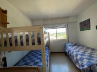 A bed or beds in a room at Acogedor apartamento con piscina y vistas al mar