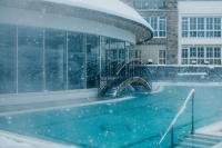 a swimming pool in the snow in front of a building at Grand Tirolia Kitzbühel - Member of Hommage Luxury Hotels Collection in Kitzbühel