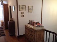 a room with a wooden dresser with books on it at La Maison de la Riviere B&amp;B in Espéraza