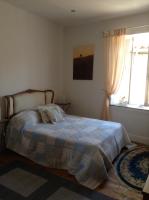 a bedroom with a bed with a blanket and a window at La Maison de la Riviere B&amp;B in Espéraza