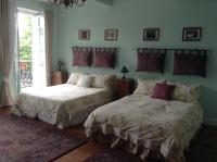 two beds sitting next to each other in a bedroom at La Maison de la Riviere B&amp;B in Espéraza