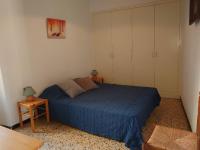 a bedroom with a blue bed and two night stands at 5COMA2 Appartement proche plage in Collioure