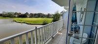 a balcony with a view of a golf course at Next to Golf-club House in Talmont