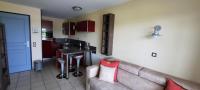 a living room with a couch and a kitchen at Next to Golf-club House in Talmont