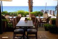 un ristorante con tavoli e sedie e l'oceano di Sunday Beach Hotel a Kusadası