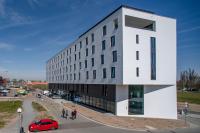 a building with a red car parked in front of it at EA Congress Hotel Aldis in Hradec Králové