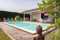 a villa with a swimming pool and a house at Beautiful Louisiana villa sleeps 6 with pool in Mios
