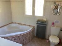 a bathroom with a tub and a toilet and a window at B&amp;B Macchia Verdata avec piscine in Monacia-dʼAullène