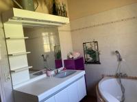 a bathroom with a sink and a tub and a mirror at B&amp;B Macchia Verdata avec piscine in Monacia-dʼAullène