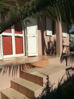 a house with a porch and a patio at LA KAZ A DADA in Sainte-Suzanne