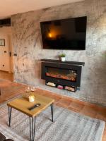 A television and/or entertainment centre at Los Nietos Apartment