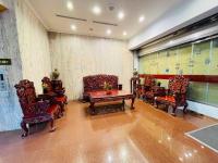 a living room with chairs and a table in a room at Abbo Hotel in Tainan