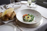 a table with a plate of food on a table at Hotel San Rocco in Orta San Giulio