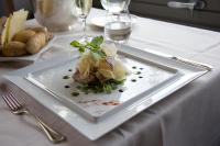 a white plate with food on a table at Hotel San Rocco in Orta San Giulio