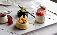 three desserts on a plate on a table at Hotel San Rocco in Orta San Giulio