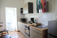 a kitchen with a sink and a counter top at Le Vieil Home, au pied de la cité médiévale in La Haute-Chapelle