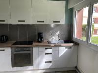 a kitchen with white cabinets and a sink and a window at Nouveau !! Bel appartement à Fécamp tout près de la plage, gare et voie verte in Fécamp